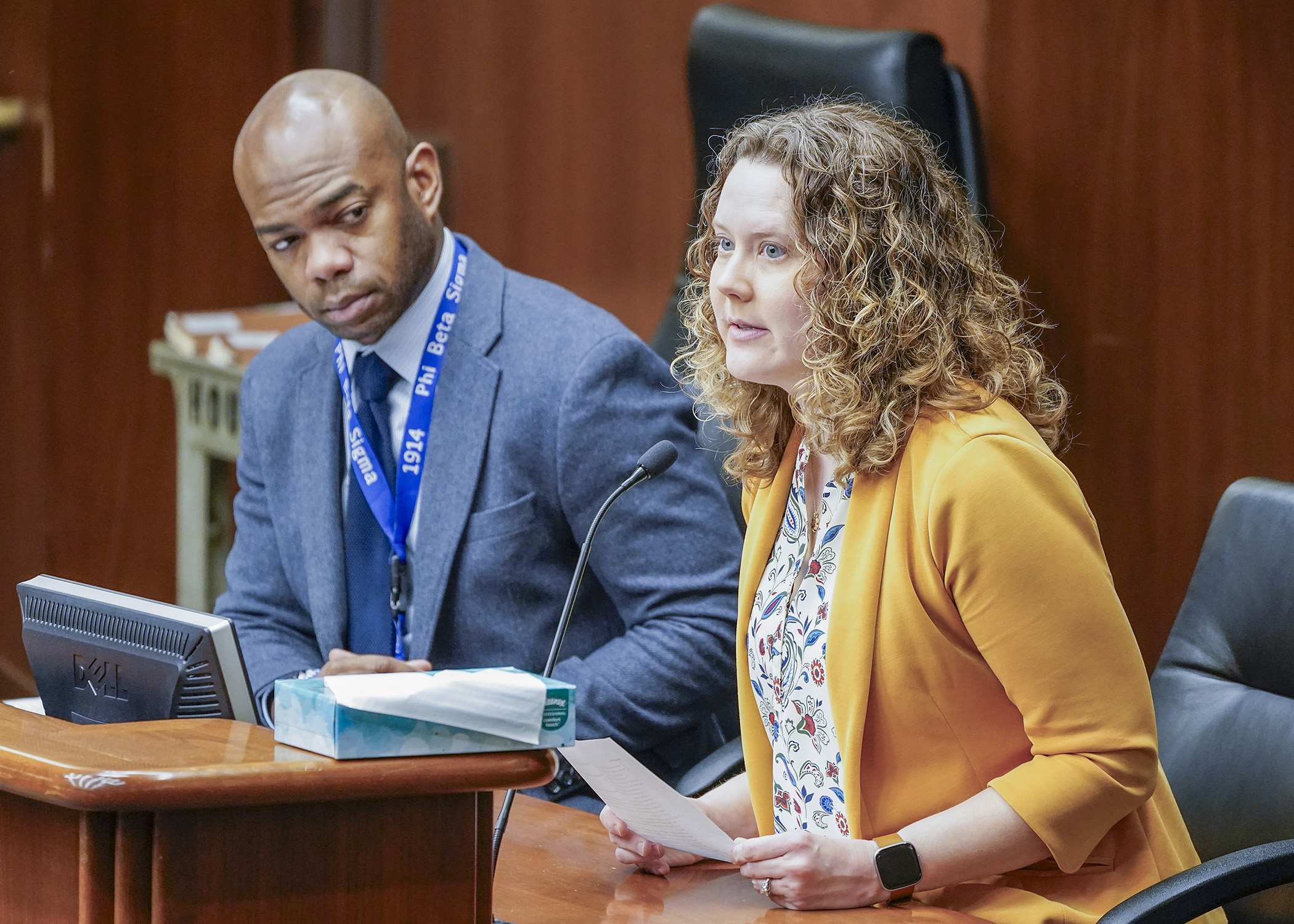 Bloomington City Clerk Christina Scipioni testifies before the elections committee March 13 in support of a bill sponsored by Rep. Cedrick Frazier, left, that could provide for ranked-choice voting. (Photo by Andrew VonBank)